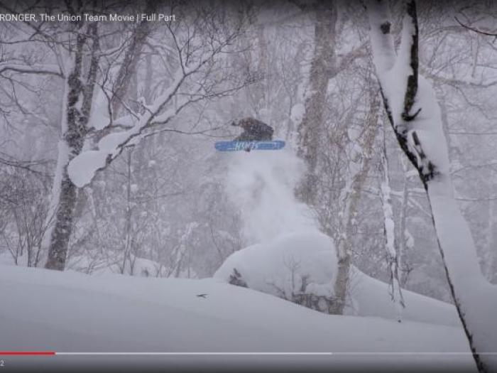 A still image of a youtube frame of a snowboarder doing a jump.