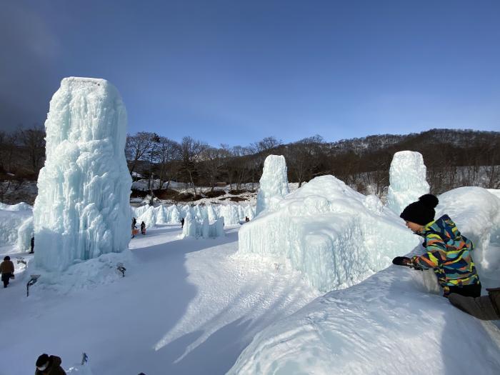 A child peers over the edge of an ice sculpture.