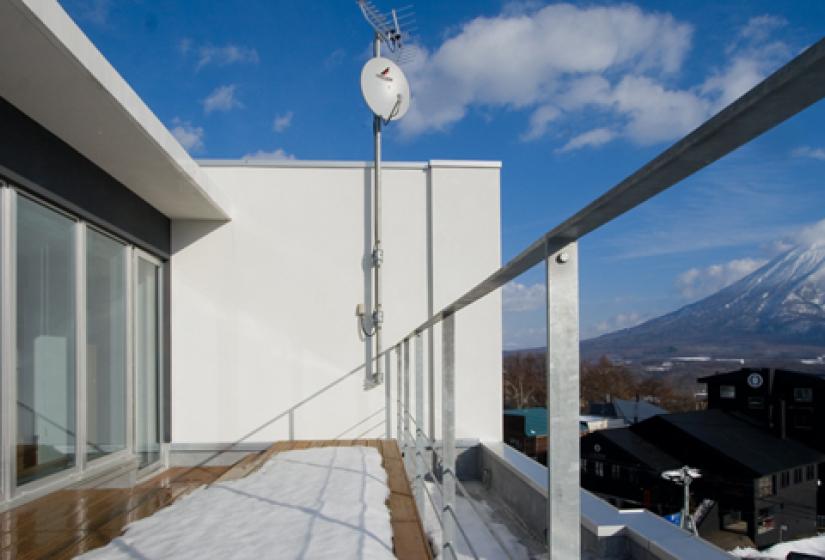 rooftop deck with railing and yotei view