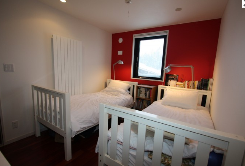 twin bedroom with exterior view and radiator heating