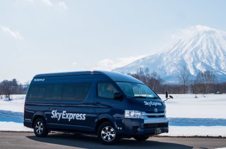 A black van with Mt Yotei in the back ground
