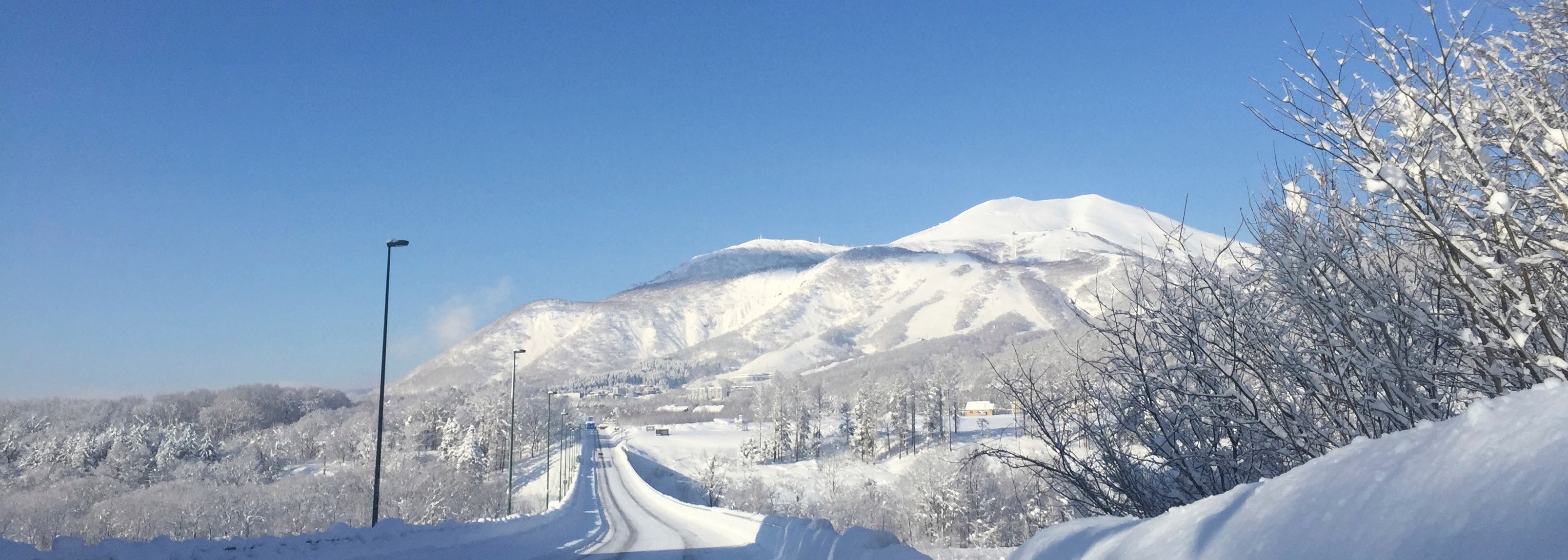 Mount Yotei snow-covered peak with winter driving scene in Niseko