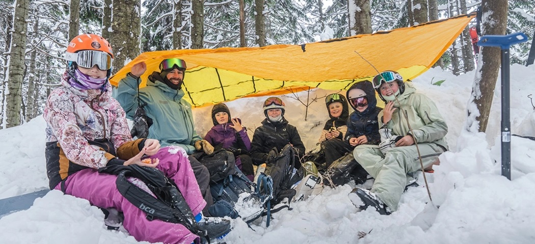 Kids under a tarp in the snow