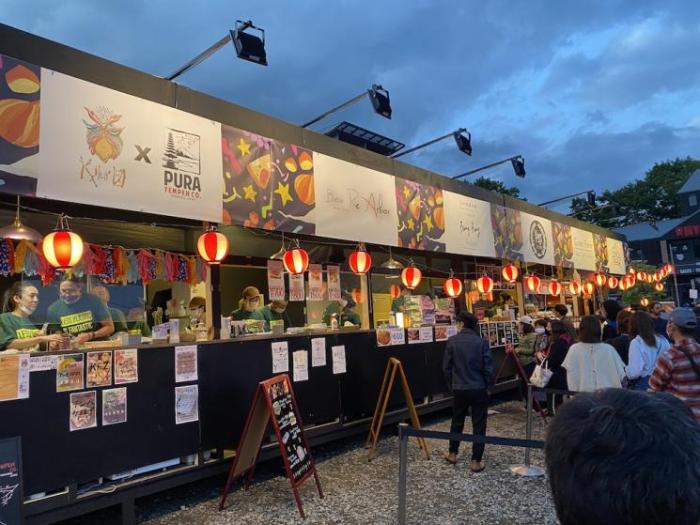 A line of colourful food stalls at the festival