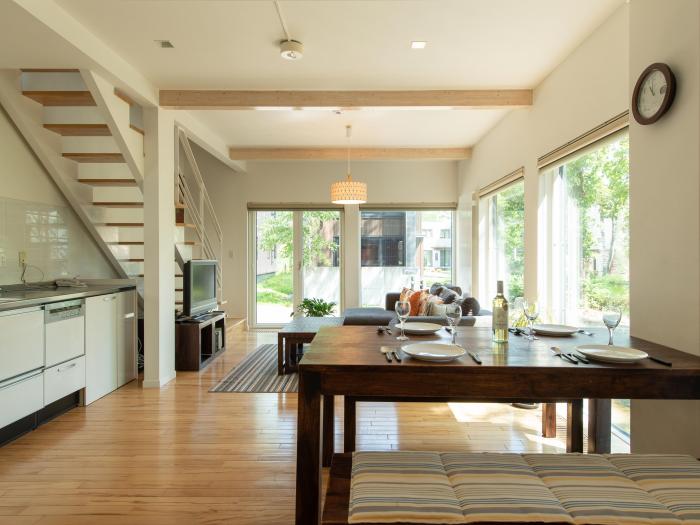 wooden floor and wooden table set for dinner