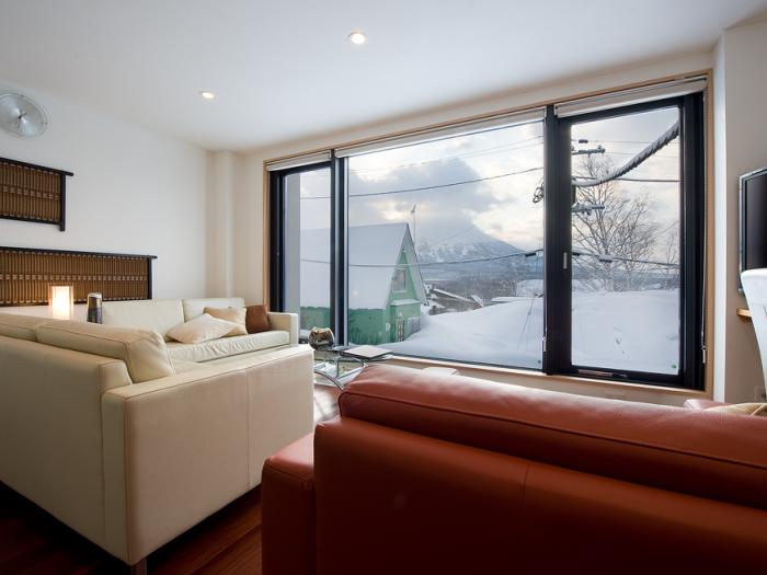 Red sofa, snowy view out of window