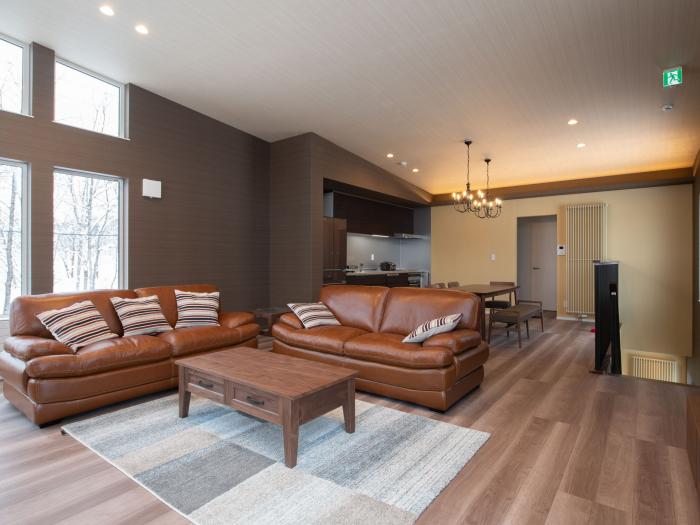 two brown leather sofas and brown coffee table