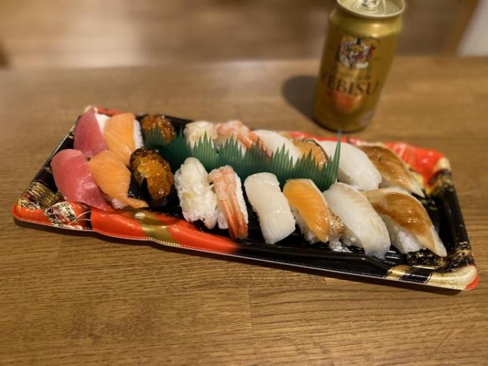 A selection of sushi in a decorative rectangle tray