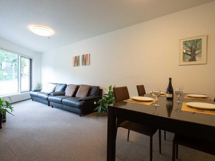 Living room view with table set and 2 black sofas