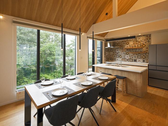 A set dining table with kitchen behind.