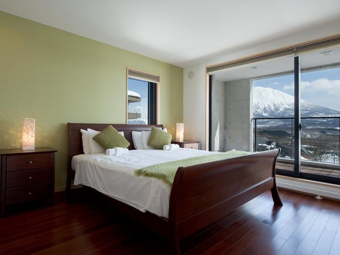 A bedroom with wooden floors and Mount Yotei view