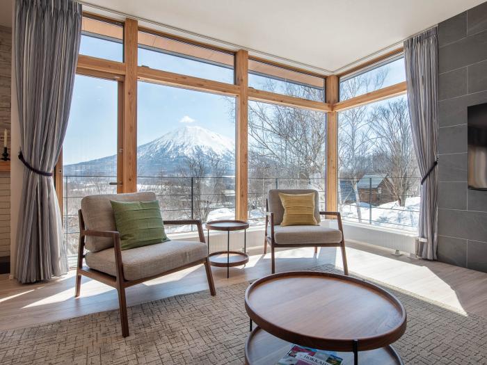 Two sets in front of large window with mountain view
