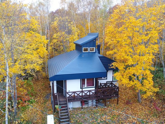 A retro building surrounded by autumn leaves