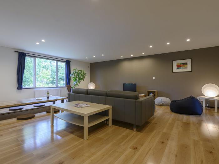 A spacious lounge with wooden floors