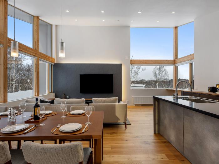 A sining table and kitchen bench with wooden floors