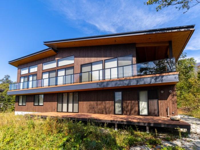 Chalet Lotus Niseko - Modern luxury ski chalet with panoramic windows, wooden exterior and spacious deck, nestled in Annupuri Village just minutes from world-class powder skiing.