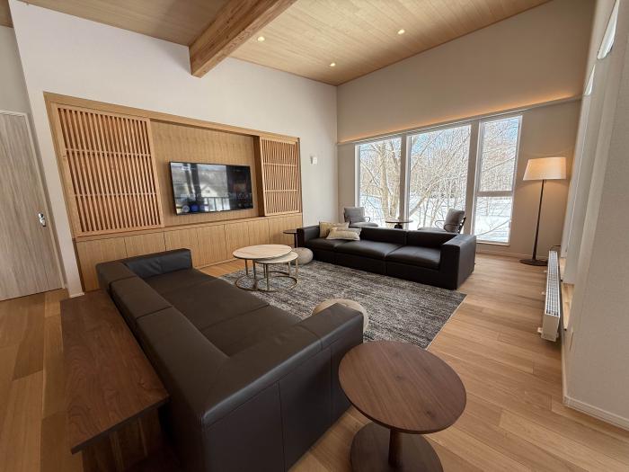 Two black lounge suites in a living room