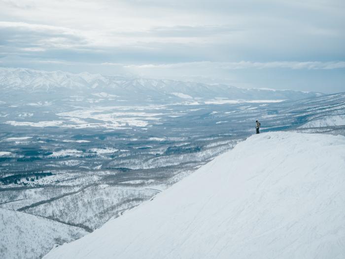 A man standing on a snowy ridge