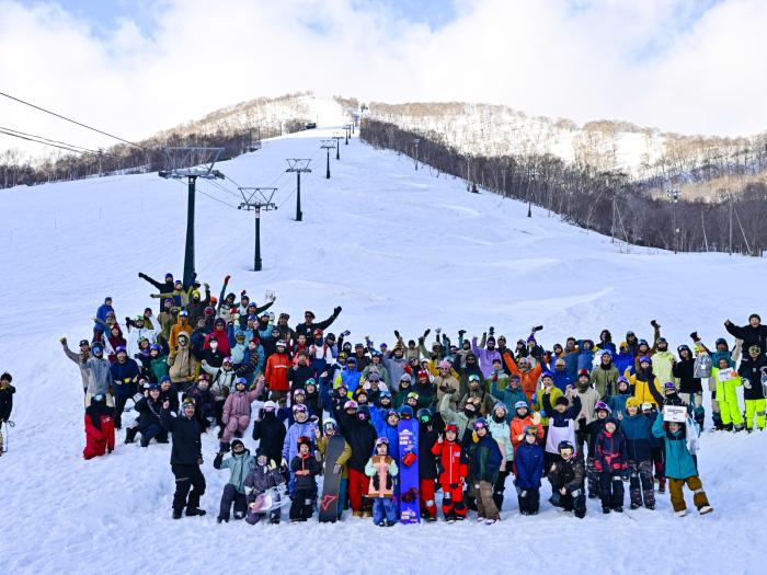A crowd of skiers and snowboarders on a ski slope