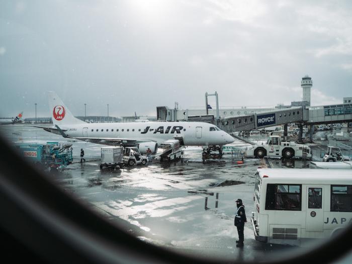 An airport scene through a plane window