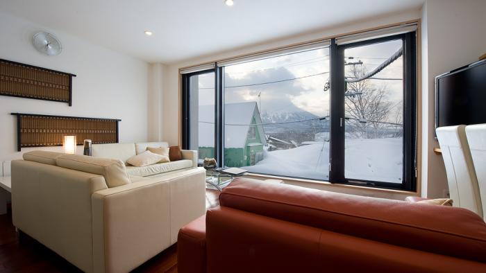 Red sofa, snowy view out of window