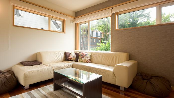 Light tan sofas with coffee table on striped mat