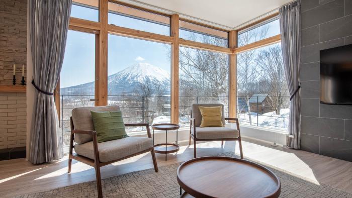 Two sets in front of large window with mountain view