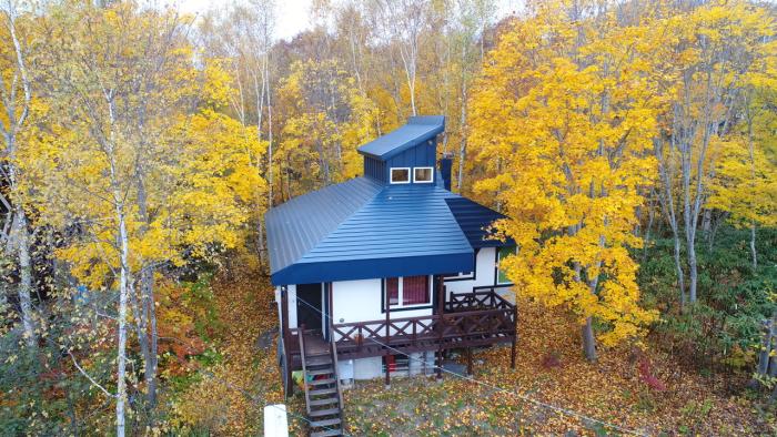 A retro building surrounded by autumn leaves