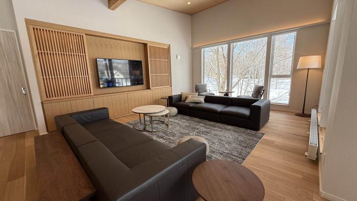 Two black lounge suites in a living room