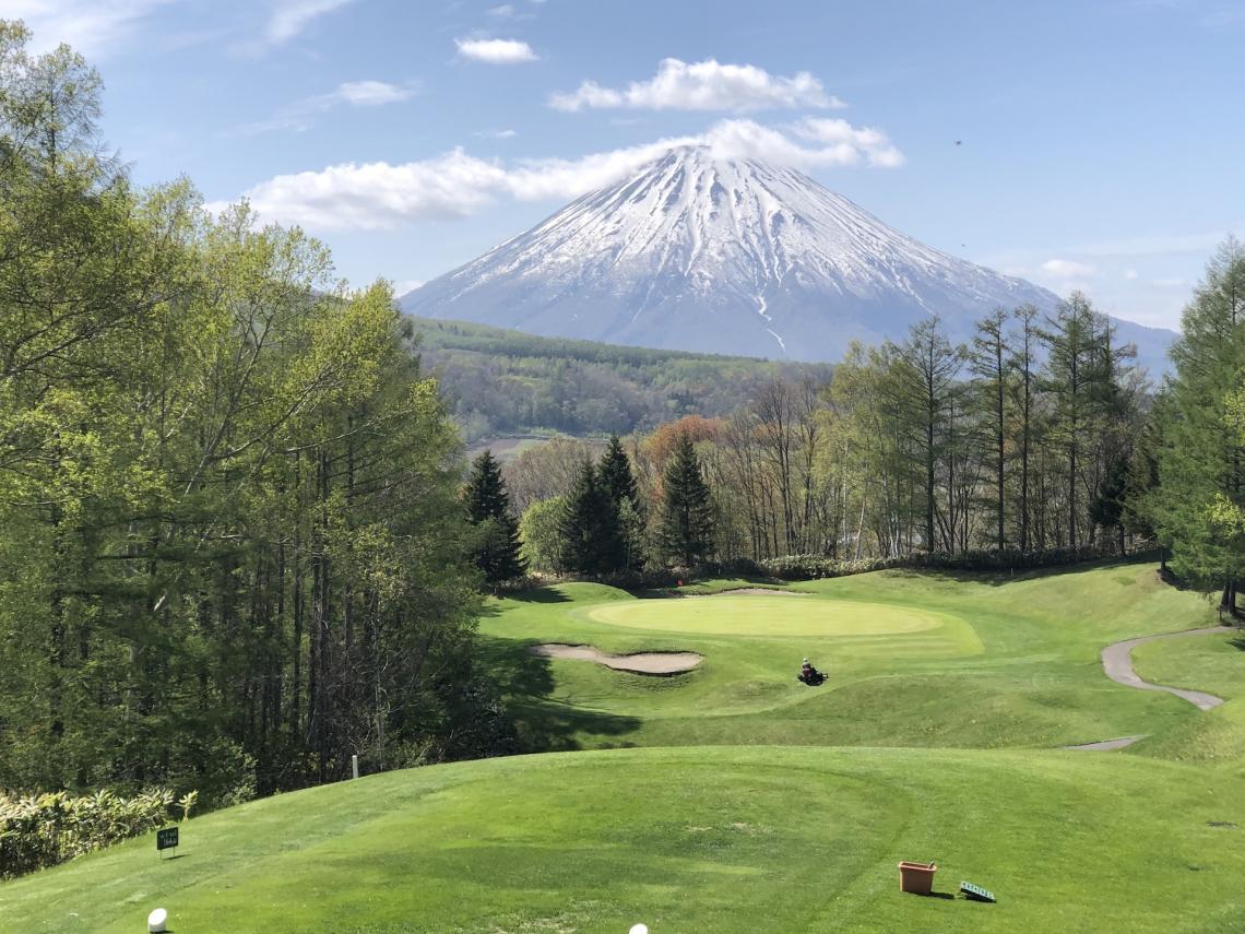 Golf course greens with Mount Yotei in the back bround