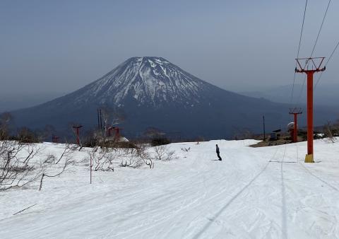 a lone snowboarder with Mount Yotei in the back ground