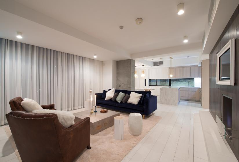 living area with 2 leather chairs and a blue sofa