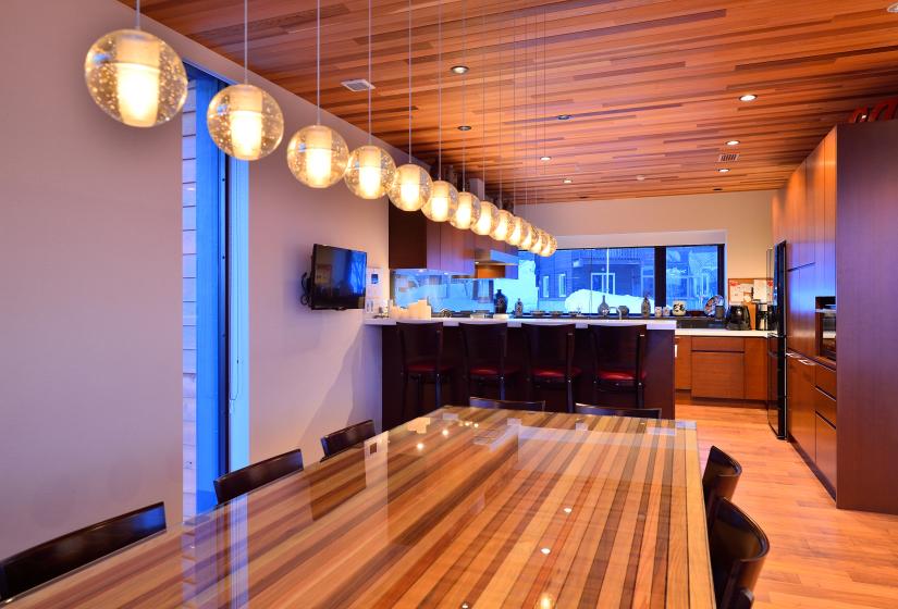 kitchen table with fancy lighting and bar counter in background