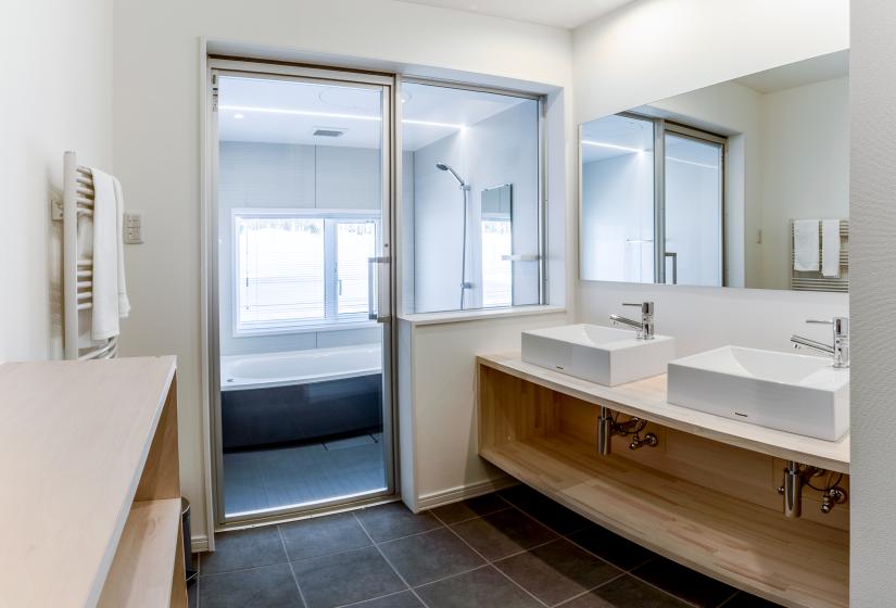 spacious washroom with shower, tub, and 2 sinks