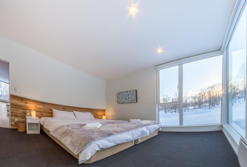 bedroom with floor to ceiling window views 