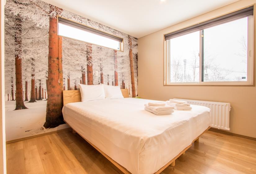 bedroom with wintery forest wallpaper