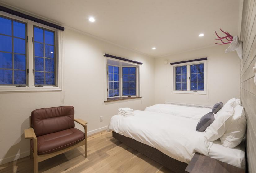 Bedroom, chair and antlers above bed