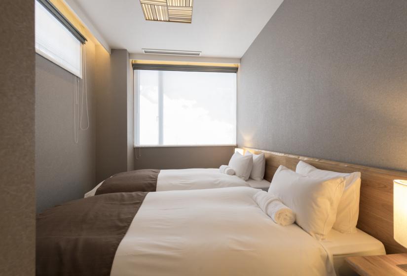 Bedroom with made bed and snowy view