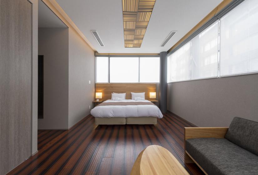 Bedroom with hardwood floors, orange light shade and double bed