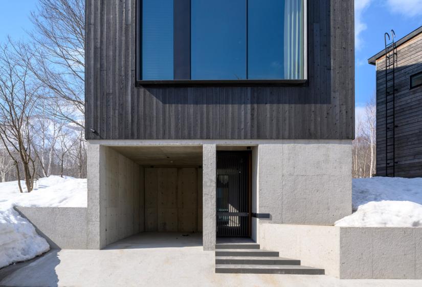 Front door and garage with concrete foundation