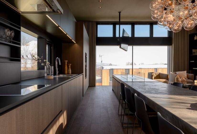 Kitchen and dining table with large window views, TV mounted on ceiling