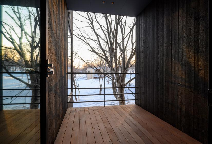 front porch with wood wood flooring and wall panelling