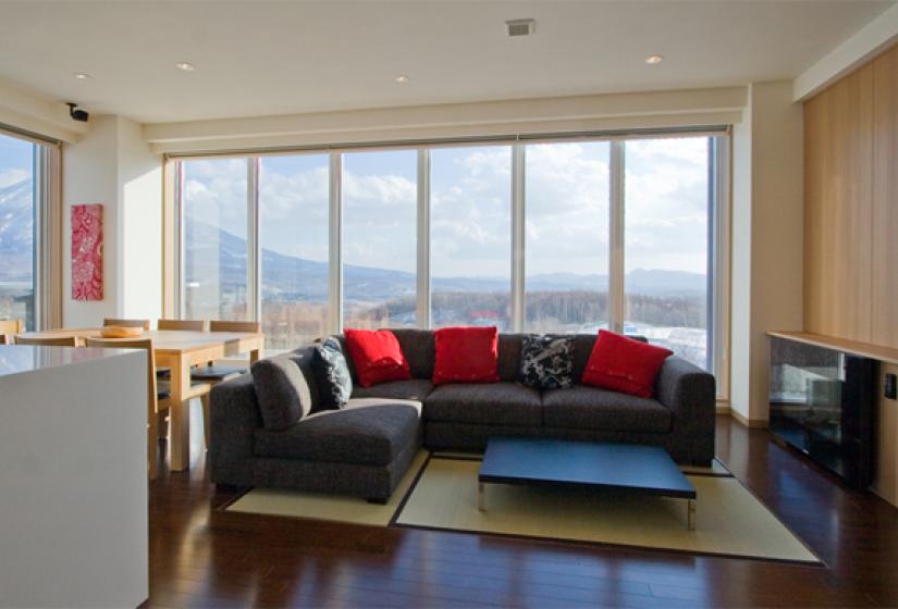 couches with coffee table and carpets forest view outside 