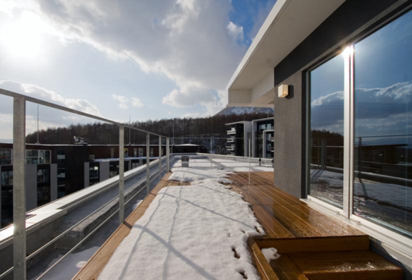 exterior deck with railing and forest view