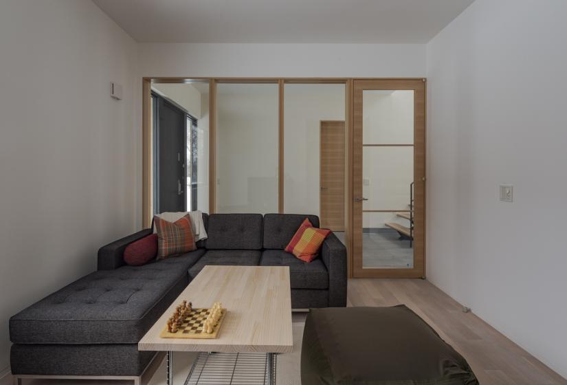 living area with couch coffee table and entranceway in background