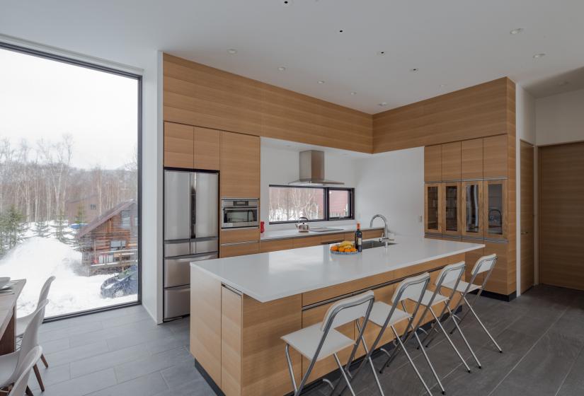 kitchen with bar and refrigerator. wood panelling