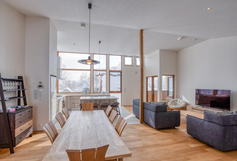 main living area with dining table and lights, wood flooring