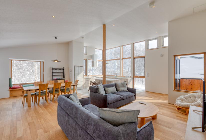 main living area with dining table couches and large windows