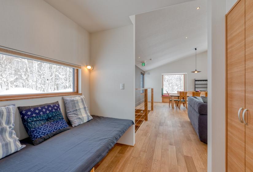 main hallway with couch and kitchen in background