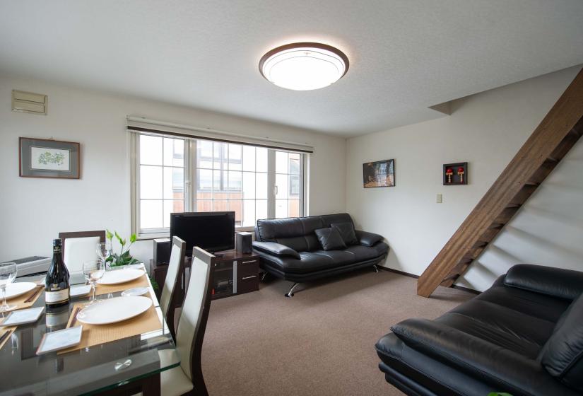 black sofas in living room with TV